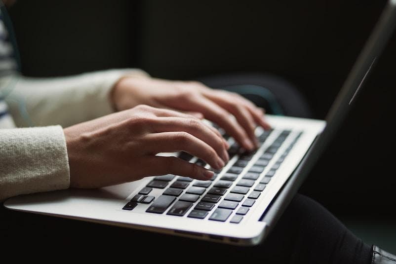 Man typing on macbook