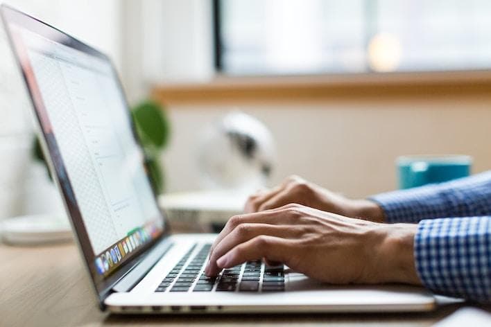 Man typing on macbook